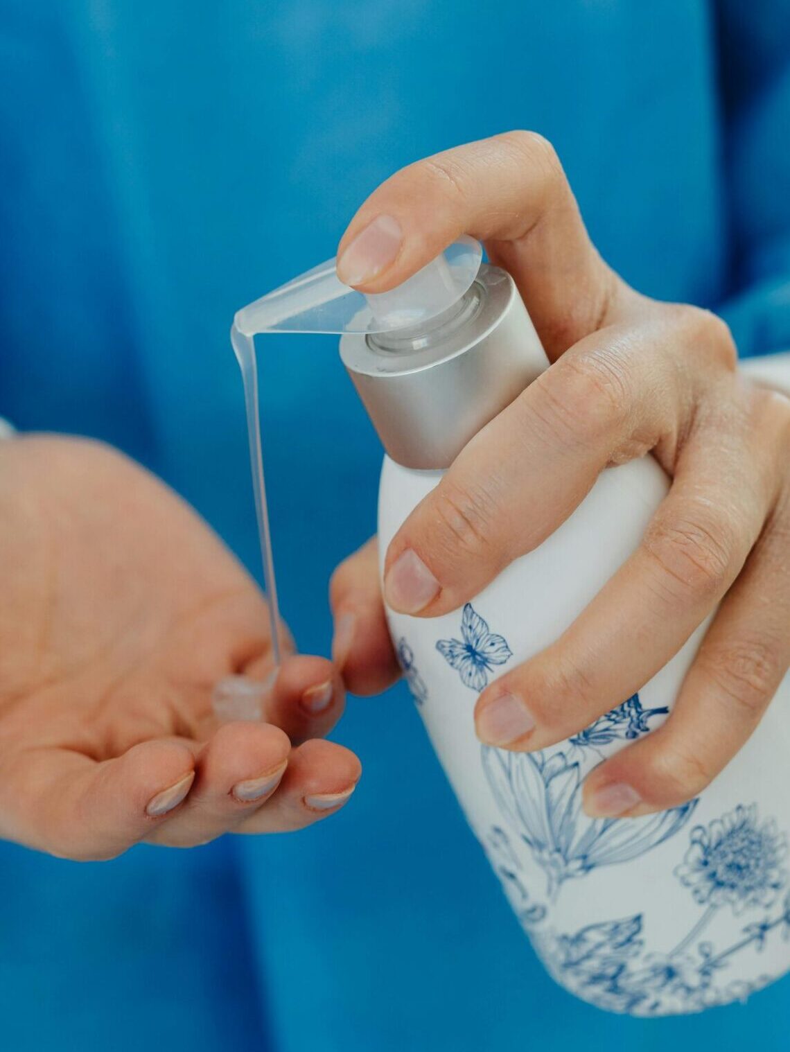 Detailed image of hands applying hand sanitizer, emphasizing hygiene and cleanliness.